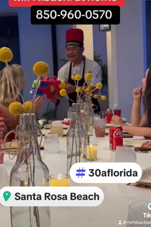 Hibachi chef cooking at a flower-decorated table in Santa Rosa Beach