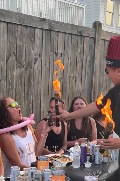 Hibachi chef’s flame show next to party guests