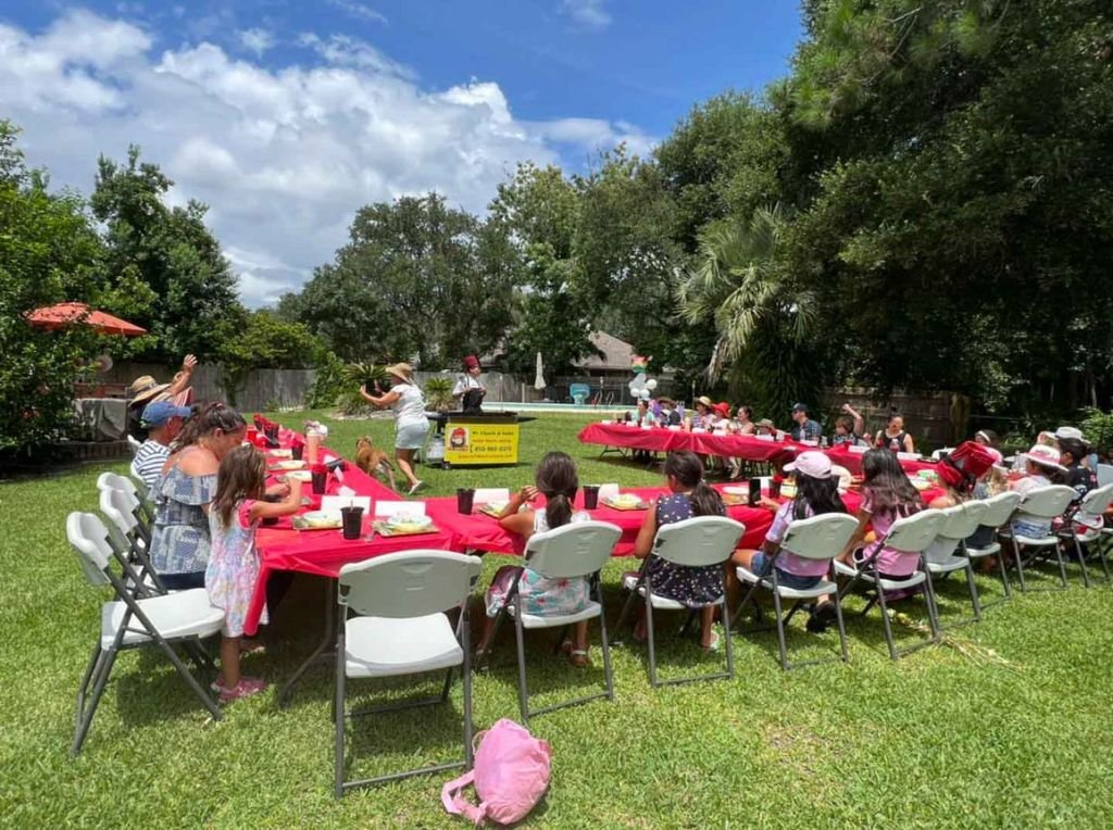 Backyard birthday hibachi party with red tablecloths