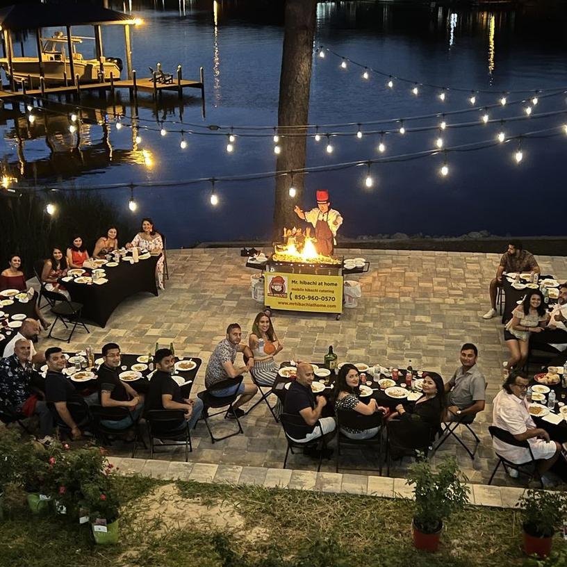 Lakeside patio hibachi dinner under string lights