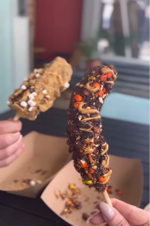 Close-up of a treat on a stick held by a guest